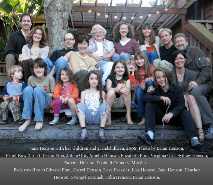 Photo of the Henson family and kids sitting on steps, with Jane Henson sitting in back