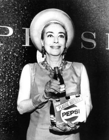 Photo of Joan Crawford holding a bottle of Pepsi and grimacing slightly