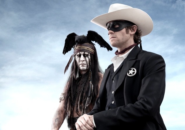 Photo of Johnny Depp in facepaint and a feather (?) winged headdress, looking at the Lone Ranger