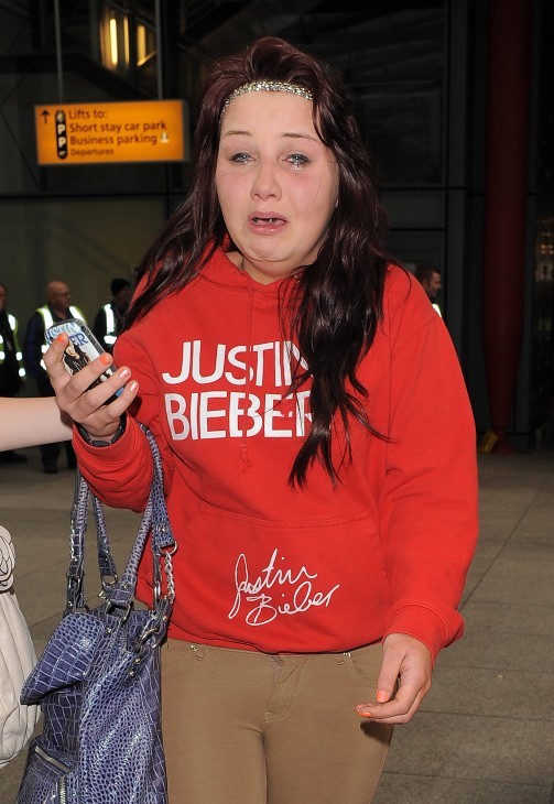 Photo of a Justin Bieber fan, same one as above, bawling in, uh, ecstasy or hysteria.