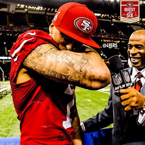 Photo of 'Kaepernicking' -- Colin Kaepernick kissing his arm for a laughing reporter