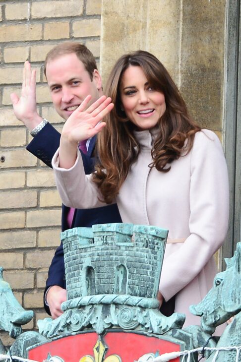 A photo of Prince William and Duchess Kate on a balcony, waving to unseen crowds