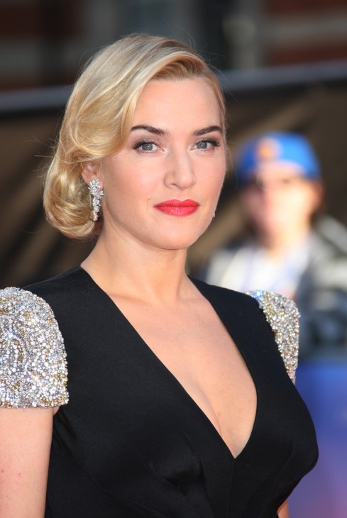 Photo of Kate Winslet in a black dress with a v-neckline, her hair in a classy curl with big dangling diamond-type earrings