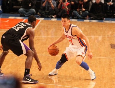 Photo of Jeremy Lin as he dribbles against a defender in Madison Square Garden 