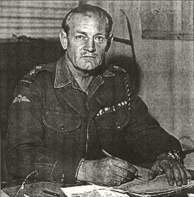 A photo of Mad Jack Churchill, in army dress but sitting at desk, pen in hand