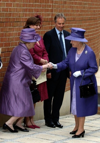 A photo of Margaret Thatcher curtseying to Queen Elizabeth, both in purple outfits, both now older women