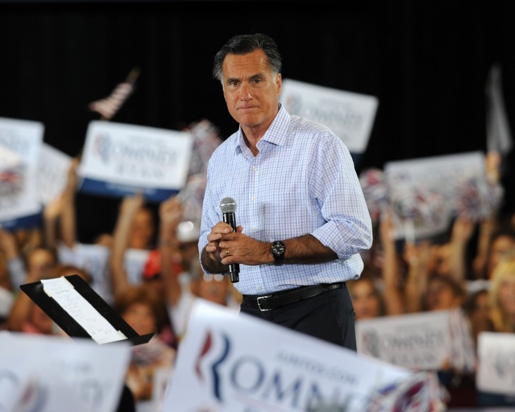 Photo of Mitt Romney standing in a crowd of 'Romney for President' signs