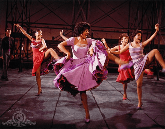 Rita Moreno hitches her skirt as she dances in West Side Story