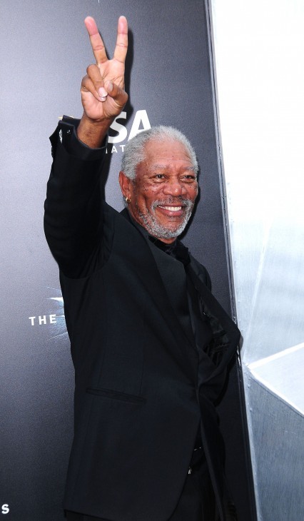 Photo of Morgan Freeman holding up two fingers in a V sign