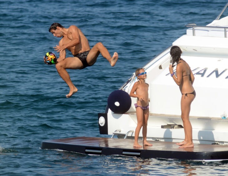 Rafael Nadal photo, with the tennis star flying off a yacht with a volleyball in hand