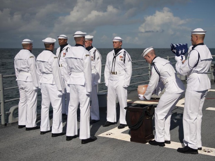 Photo of Neil Armstrong's urn being placed on deck by sailors