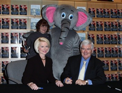 Photo of Newt Gingrich and wife Callista posing with a woman and a person in an elephant costume