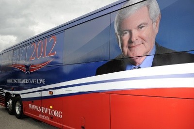 A photo of Newt Gingrich's campaign bus with his photo and red, white, and blue stripes