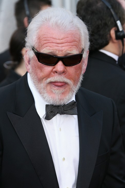 Photo of Nick Nolte, in a tuxedo and sunglasses, looking a little scary with his tongue half out