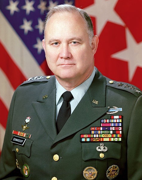 A photo of Norman Schwarzkopf in a green dress outfit beribboned with medals