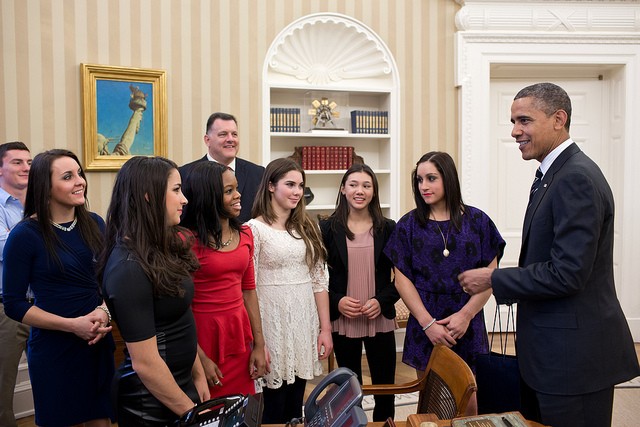 Photo of Barack Obama posing with a pack of young women in the Oval Office