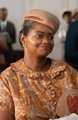 A photo of Octavia Spencer in church garb and a tiny hat in 'The Help'