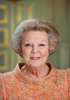 Official photo of Queen Beatrix in a sensible blouse and hairdo, smiling