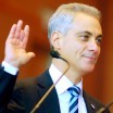 Rahm Emmanuel's missing finger is really the top half of his middle finger, cut off between the second and third knuckle. He stands in a blue suit and tie, surrounded by family, as he raises his hand to take the oath of office.
