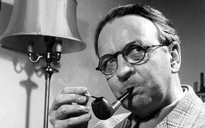 A photo of Raymond Chandler, lighting his pipe and looking wryly to his left
