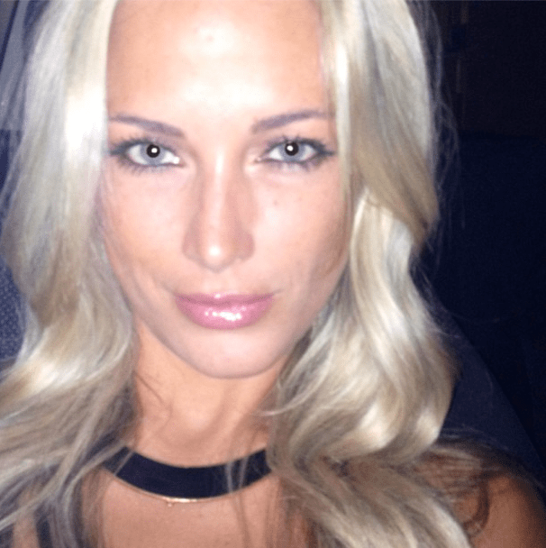 A photo of a blonde, blue-eyed Reeva Steenkamp smiling for a snapshot