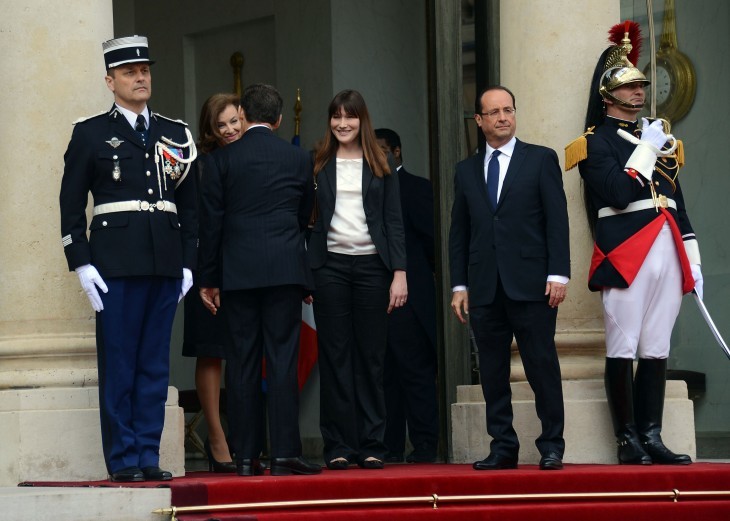 All four stand at the top of the stairs, as Sarkozy shakes hands with Valerie Trierweiler