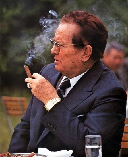 Tito smoking a cigar like a Bond movie villain
