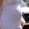 North West baby photo (in utero in Kim Kardashian, who walks in a white dress with a visible pregnancy bump)