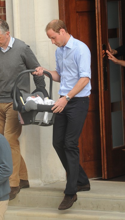 Royal baby photo, with Prince William holding the future king in a car carrier