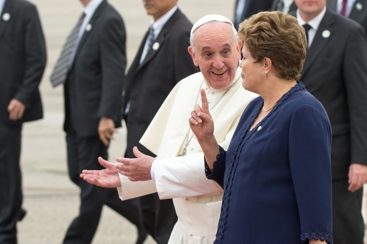 Photo of Pope Francis smiling and chatting with a woman