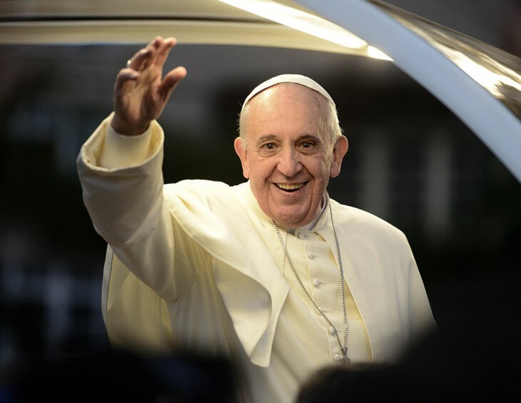 Pope Francis waves to crowds from his popemobile