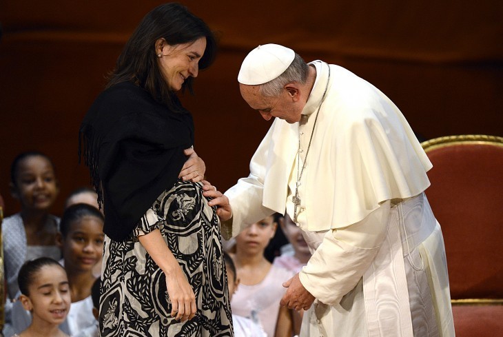 Photo of Pope Francis placing his hand on the belly of a smiling pregnant woman