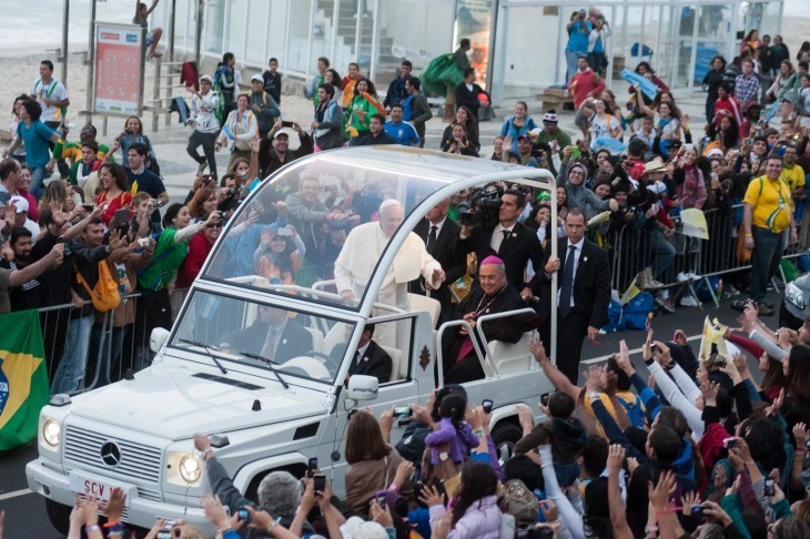 Pope Francis photo in his popemobile, with Brazilian crowds reaching out towards the car