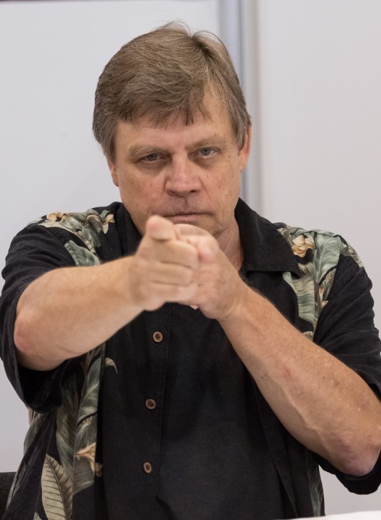 Photo of Mark Hamill, looking older, pointing at the camera with brio