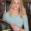 Peaches Geldof photo in a blue dress and blonde hair, smiling as she pauses by a car door
