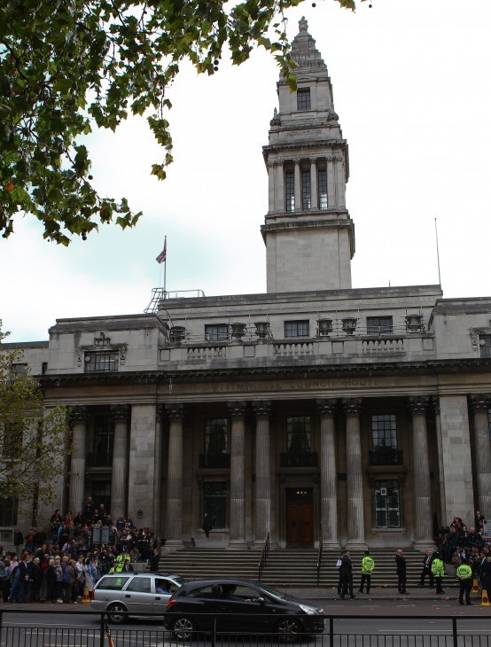 Photo of a big old stone civic building with a clock tower