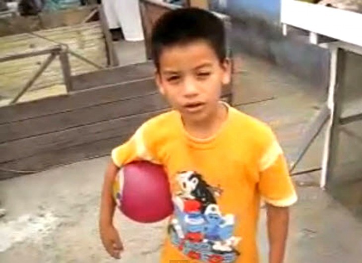 Photo of a young Neymar holding a red rubber ball