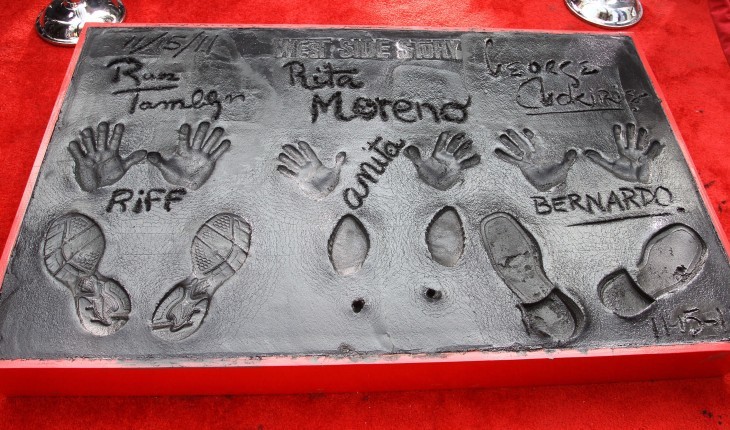 The foot and handprints of three actors in cement with their character names