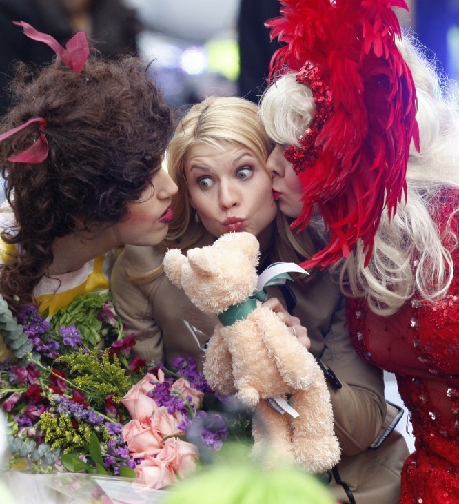Claire Danes photo, with her in a winter coat being kissed by two college men dressed as women