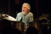 Steve Gadd is a gray-haired man with a scraggly beard, in a t-shirt. He is clearly a god among drummers.