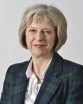 Theresa May photo, with her in a plaid blazer and looking straight at the camera
