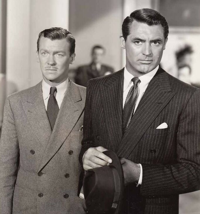 Two men in suits stand side-by-side.