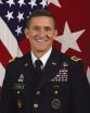 Michael Flynn photo, with Flynn smiling in an Army uniform in front of a huge flag, his chest full of ribbons