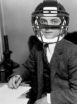 F. Scott Fitzgerald pictured at his writing desk, but now wearing a modern football helmet