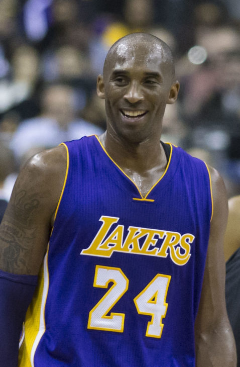 Kobe Bryant sweats and smiles during a pause in a basketball game