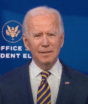 Joe Biden is an older man in a blue suit, speaking at a microphone before a backdrop that reads "Office of the President Elect"