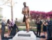 Richard T. Greener statue with people applauding