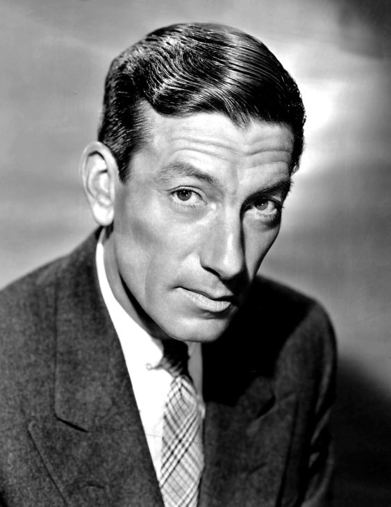 A black-and-white head shot of Hoagy Carmichael, wearing a dark suit and with his hair slicked over, looking thoughtfully at the camera