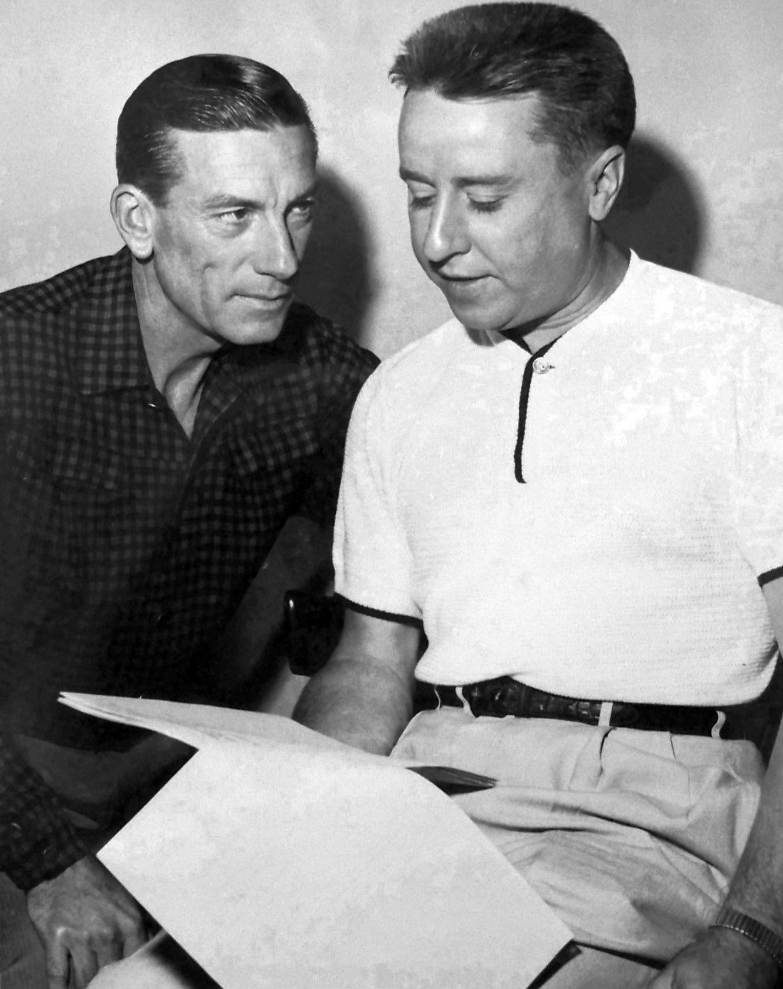 Hoagy Carmichael leers in a comical 'mad' manner at George Gobel, who sits quietly looking at a script