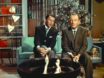Frank Sinatra and Bing Crosby sit in a mod living room with a tree behind them, singing. (They're singing, not the tree.)